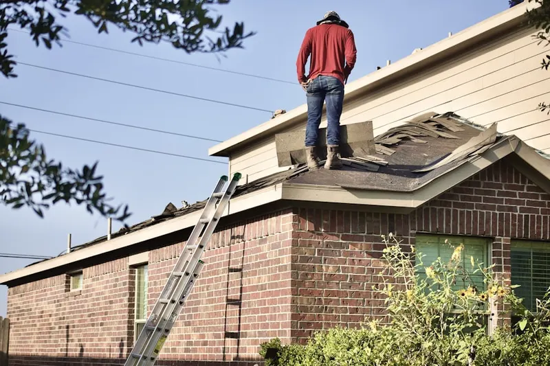 Professional roofer working on a residential roof in Sky Valley